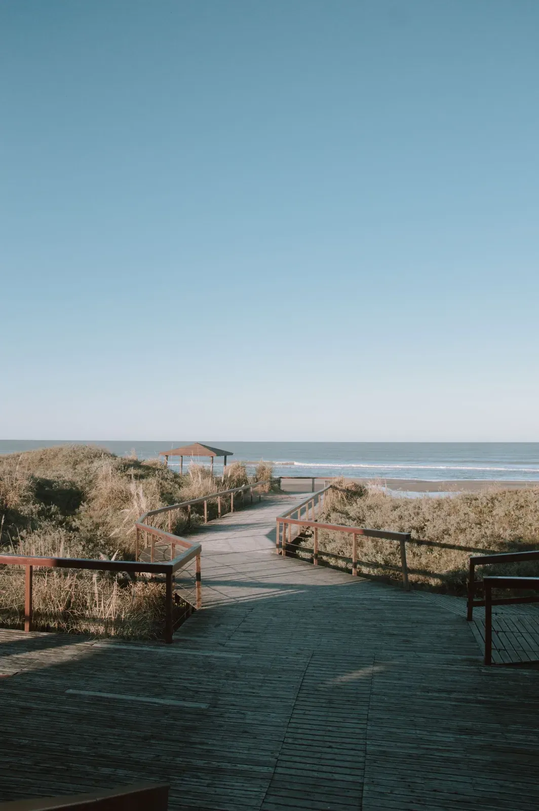 A coastal boardwalk leading to the beach