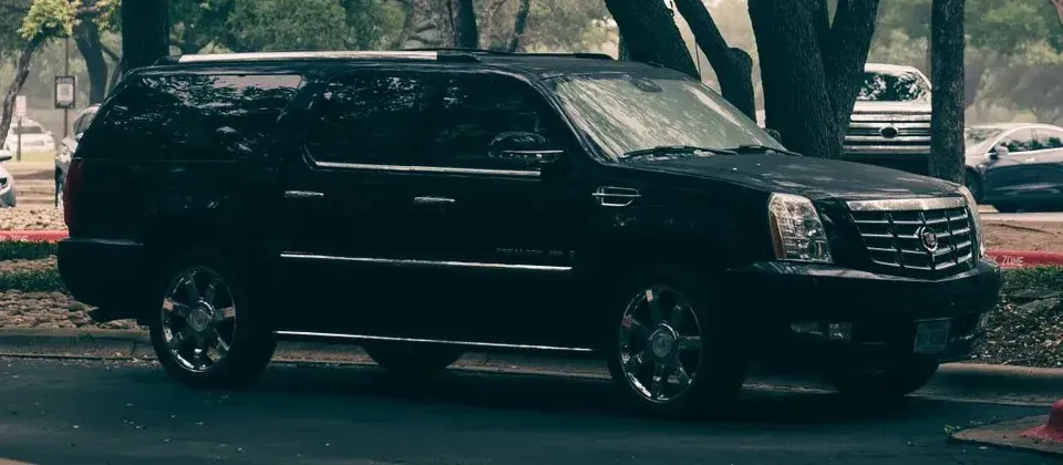 A black Cadillac Escalade seen from the side