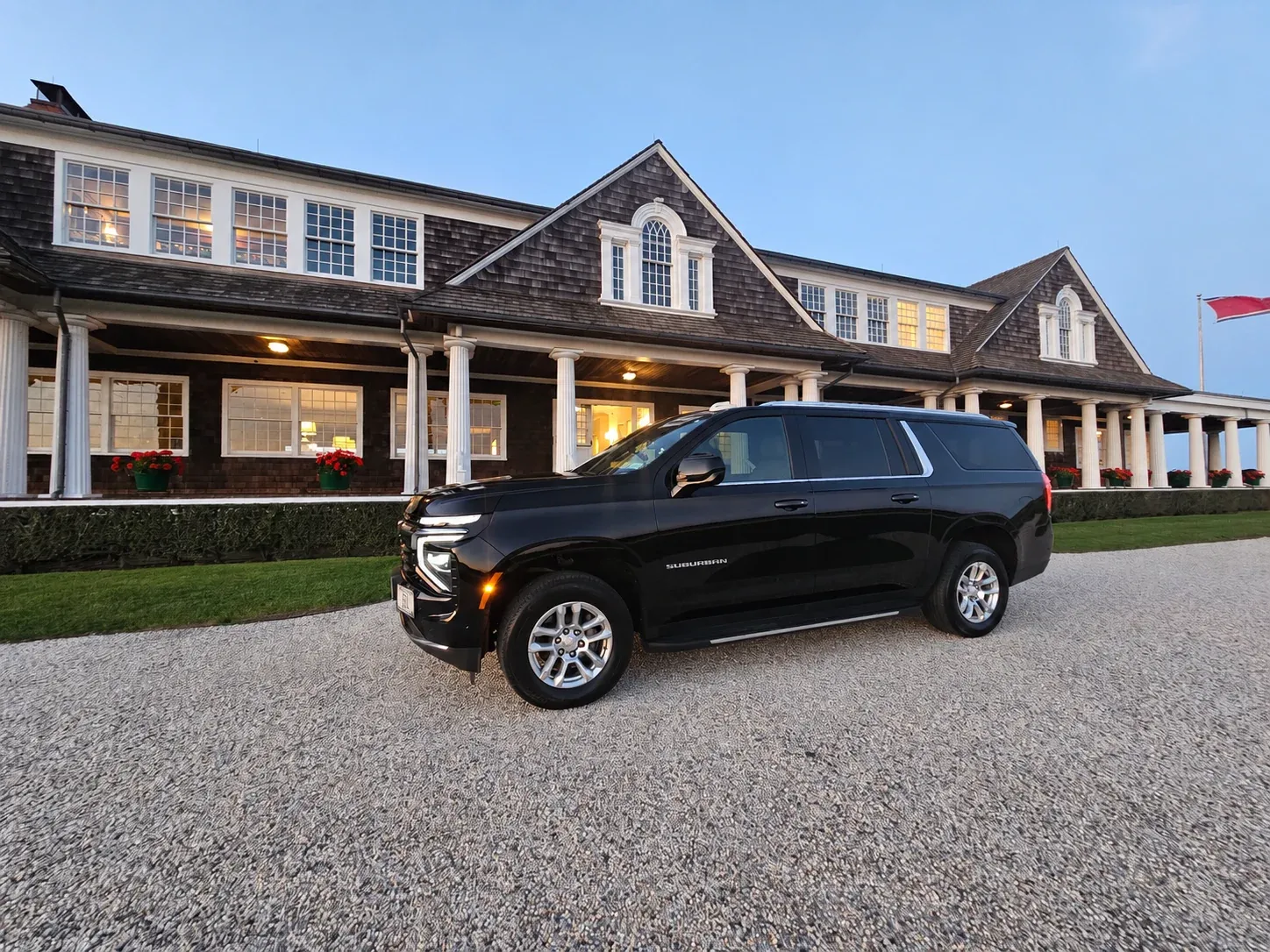 The East End Lux Suburban outside a shingled clubhouse event venue