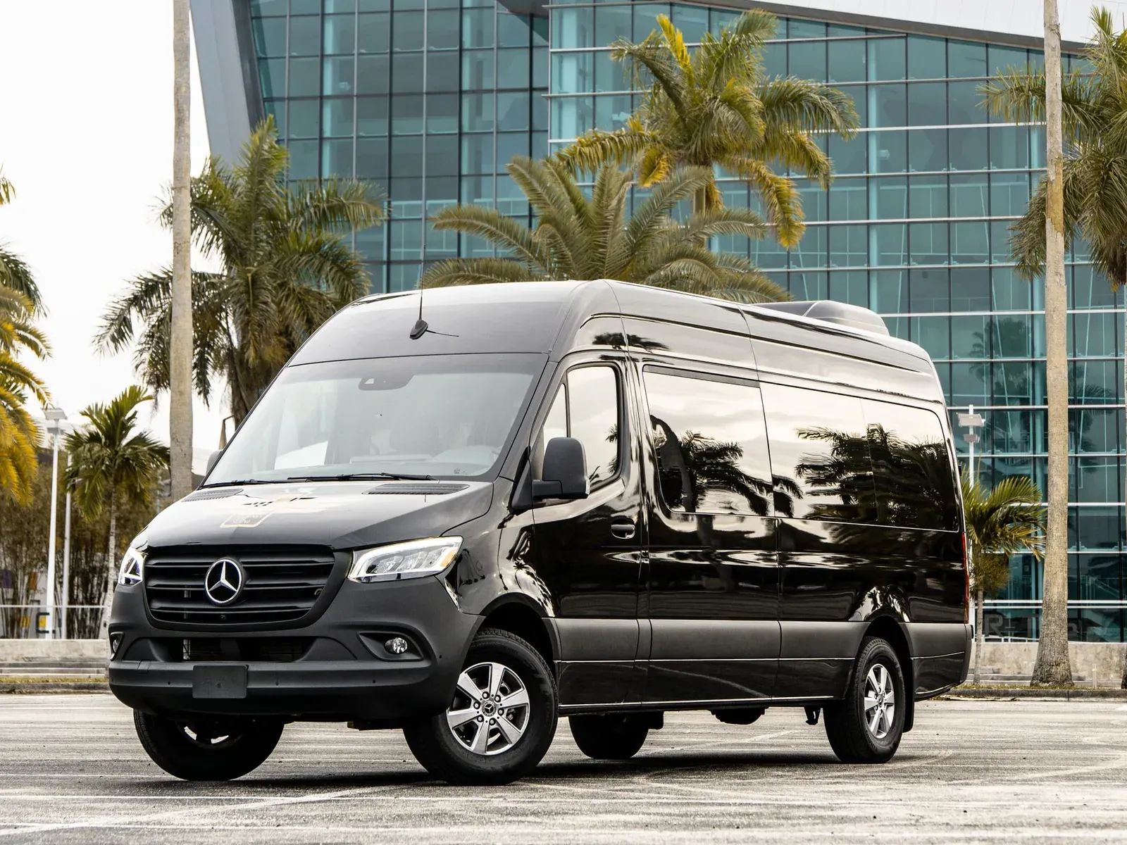A black Mercedes-Benz Sprinter passenger van