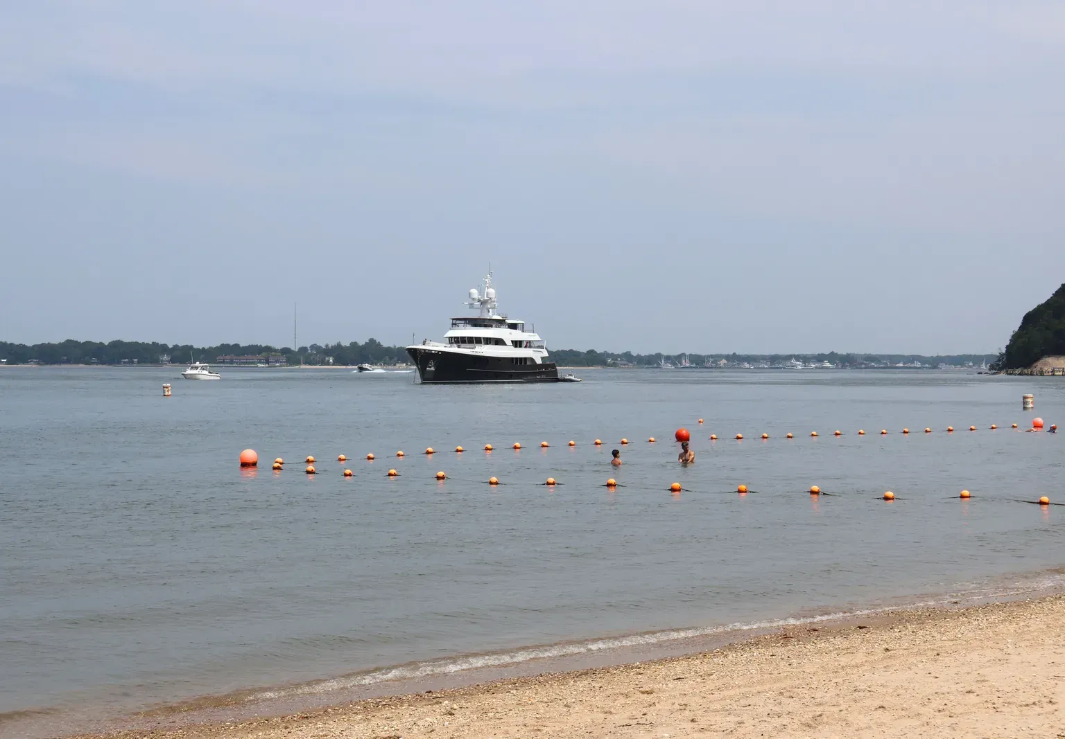 A yacht anchored off a sandy beach on Shelter Island