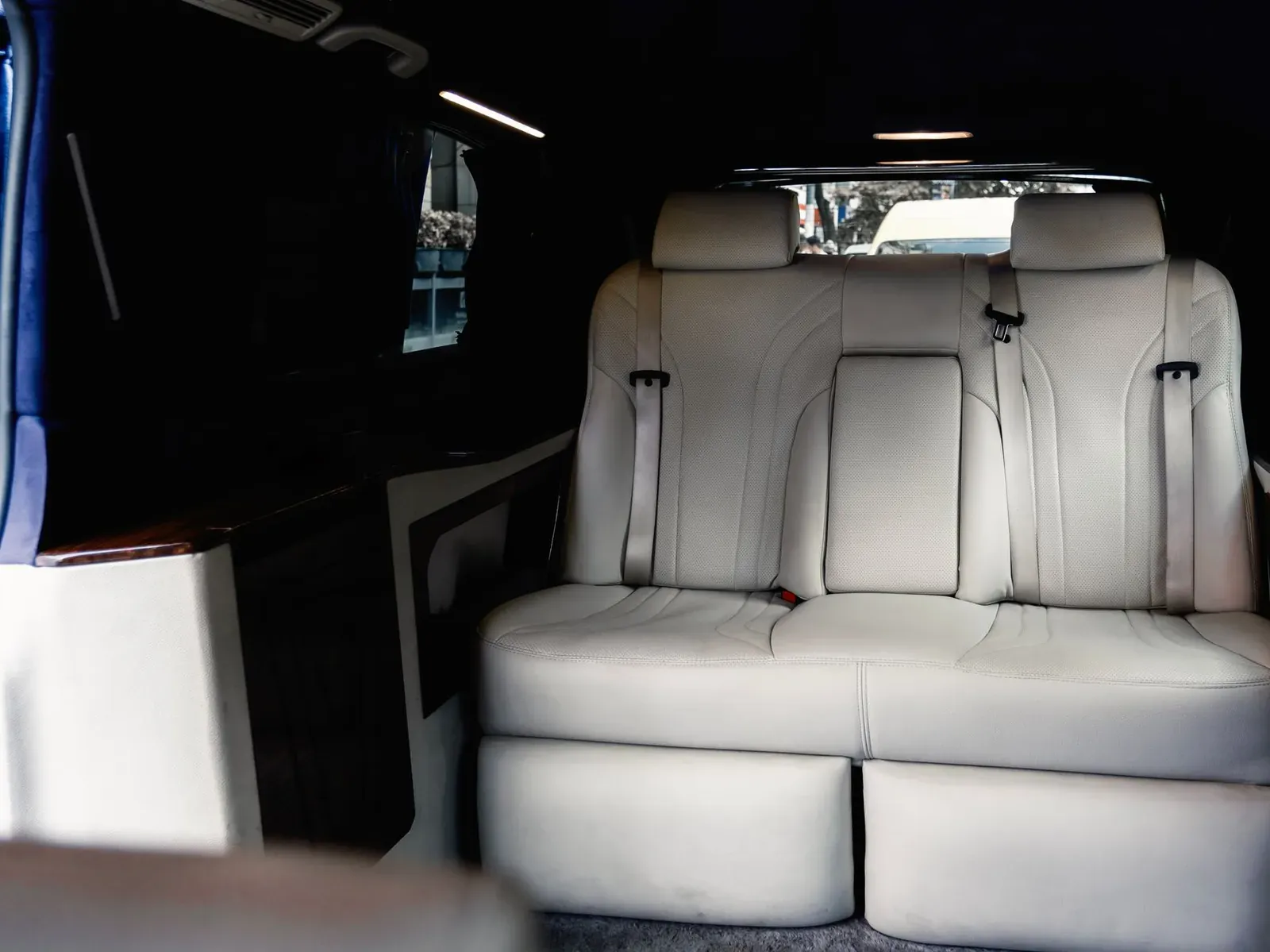 White leather limousine seating inside a Mercedes van